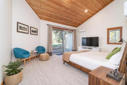 a bedroom with a large bed and a television at Lodge Room 018 in Black Butte Ranch