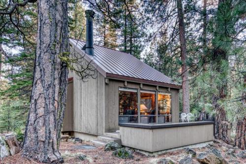 a small cabin in the woods with trees at Ridge Cabin 022 in Black Butte Ranch