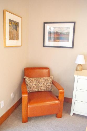 a orange chair sitting in a corner of a room at Lodge Room 016 in Black Butte Ranch