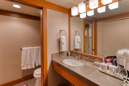 a bathroom with a sink and a mirror at Lodge Room 024 in Black Butte Ranch