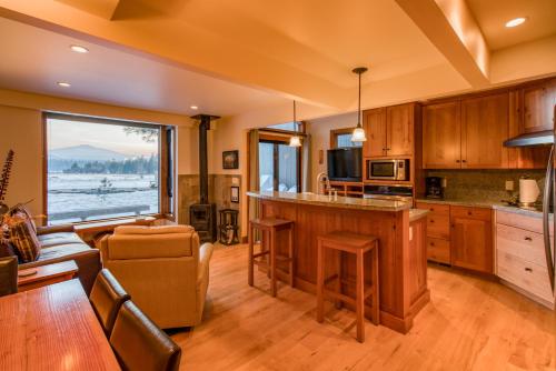 a kitchen with a large window and a living room at Country House 065 in Black Butte Ranch