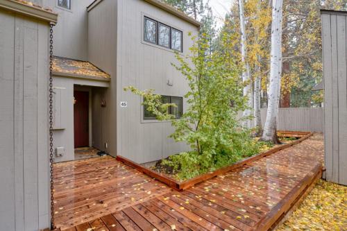 a house with a wooden deck with a tree at Country House 045 in Black Butte Ranch