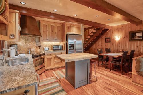 a large kitchen with wooden cabinets and a dining table at Country House 045 in Black Butte Ranch
