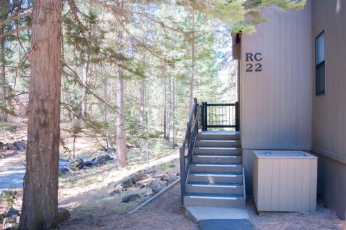 a stairway leading up to a building with a tree at Ridge Cabin 022 in Black Butte Ranch