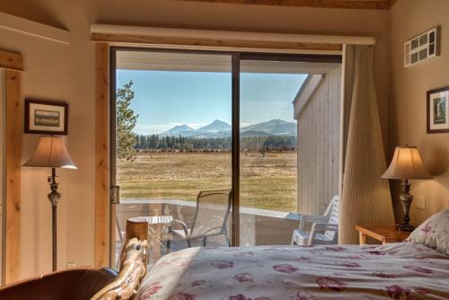 a bedroom with a bed and a large window at Lodge Room 002 in Black Butte Ranch