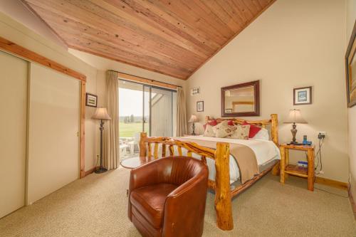 a bedroom with a bed and a leather chair at Lodge Room 002 in Black Butte Ranch