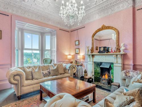 a living room with a couch and a fireplace at Greystonedale Mansion Holiday Retreat in Haltwhistle