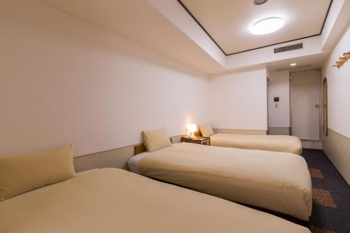 a hotel room with two beds and a room with at Ikebukuro Royal Hotel in Tokyo