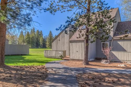 a home with a barn and a driveway at Golf Condo 098 in Black Butte Ranch