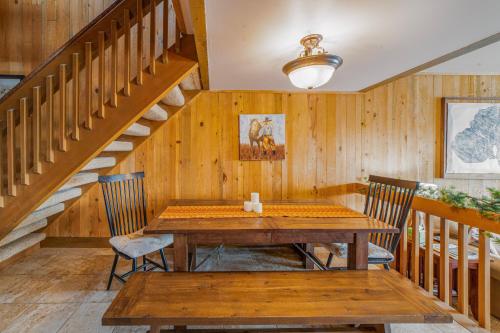 a dining room with a wooden table and stairs at Country House 071 in Black Butte Ranch