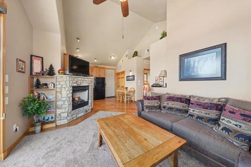 a living room with a couch and a fireplace at Teepee Mountain 12A Condo in Estes Park