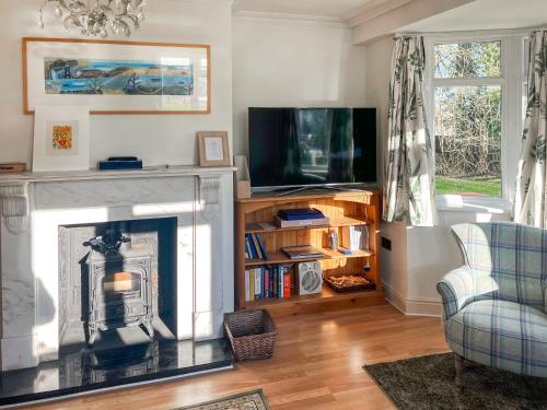 a living room with a fireplace and a tv at Island House - Uk51001 in Little Baddow