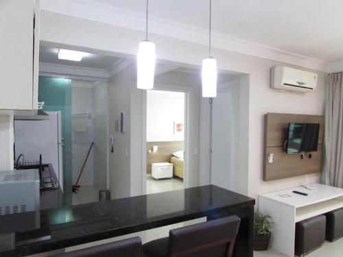 a kitchen with a black counter top in a room at Bombinhas summer bech in Bombinhas