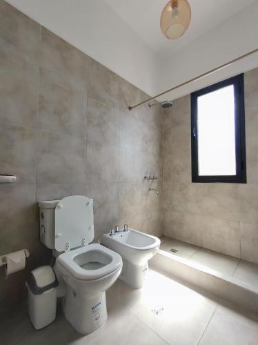 a bathroom with a toilet and a sink at Algarrobos in Cafayate