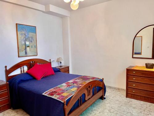 a bedroom with a bed and a dresser and a mirror at Casa Vista Hermosa Rute in Rute