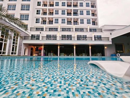 a swimming pool in front of a building at Le Erawan Phang Nga Hotel in Phangnga