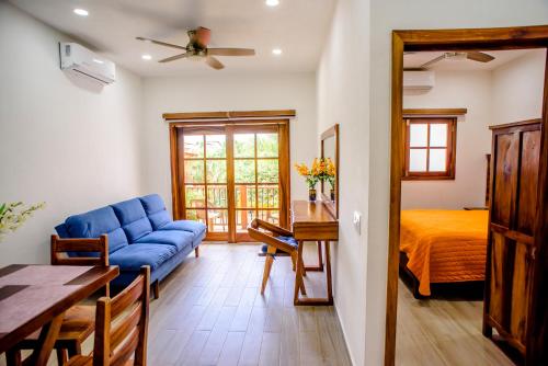 a living room with a blue couch and a bed at Sanpanchobungalows in San Francisco