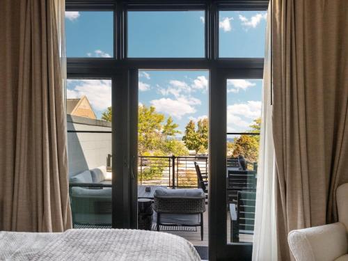 a bedroom with a view of a balcony at Luxury TC Loft: Historic Condo! in Traverse City