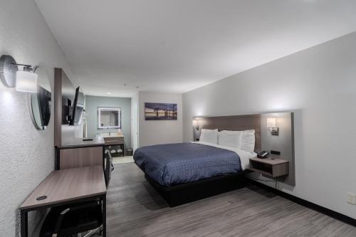 a hotel room with a bed and a desk at Executive Inn of Arlington, Near AT&T Stadium in Arlington