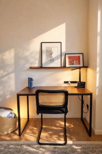 a desk with a chair in a room at Westown Studio Apt Near Fiserv, Baird, and Theater District in Milwaukee