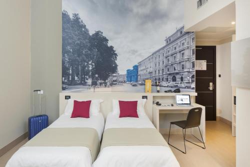 Ένα ή περισσότερα κρεβάτια σε δωμάτιο στο B&B Hotel Trieste