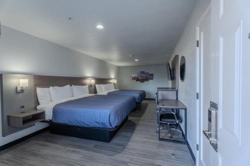 a hotel room with a large bed and a desk at Executive Inn of Arlington, Near AT&T Stadium in Arlington