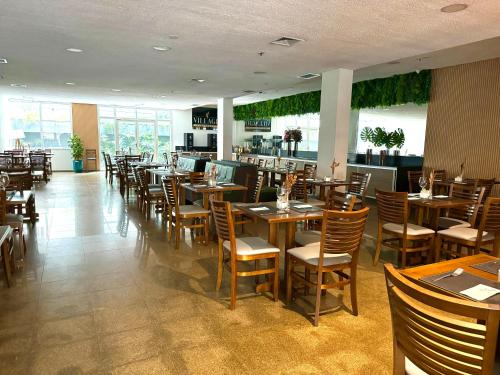 a dining room with wooden tables and chairs at AV Paulista - SP - Centro in São Paulo
