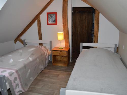 a bedroom with two beds and a table with a lamp at Gîte charmant à 30 min d'Amboise - FR-1-381-145 in Saint-Nicolas-des-Motets
