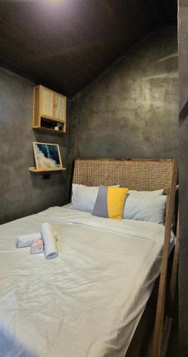 a bedroom with a large bed with white sheets at Casa Elia San Juan La Union Beach Cabin in San Juan