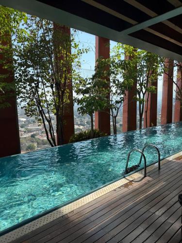 a large swimming pool on a building with trees at The Reforma 27 Grand in Mexico City