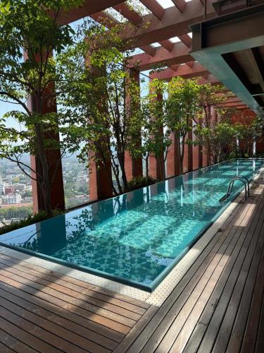 a swimming pool on top of a building at The Reforma 27 Grand in Mexico City