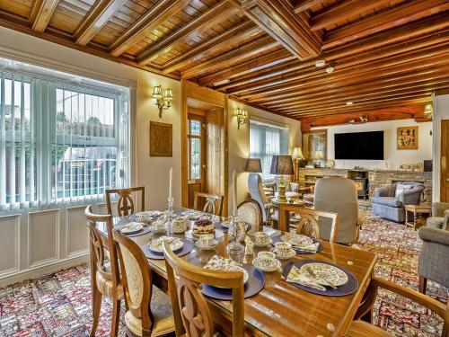 a dining room with a table and chairs and a living room at Steppe Haugh in Hawes