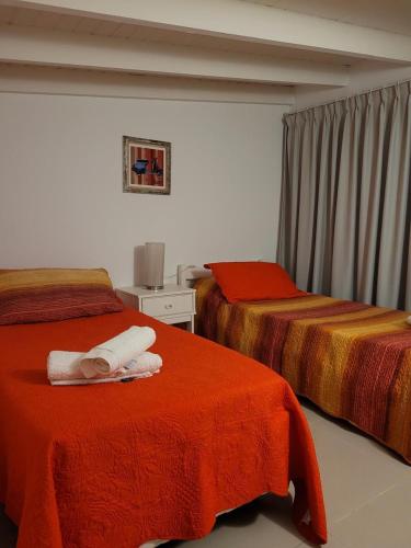 a bedroom with two beds with towels on them at Departamento morderno y centrico-Paseo Plaza in Navarro