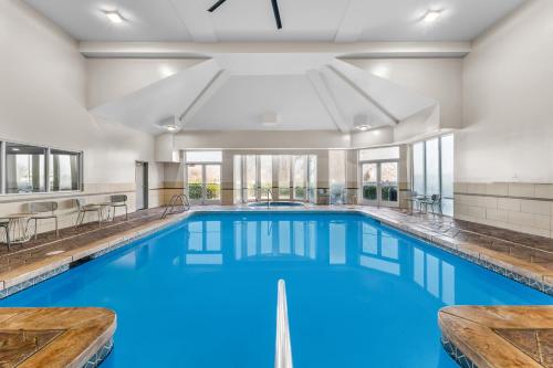 a large pool with blue water in a building at Spark by Hilton Salt Lake City Central in Salt Lake City