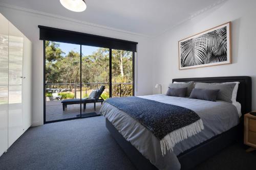 a bedroom with a bed and a sliding glass door at Ablac House in Glenlyon