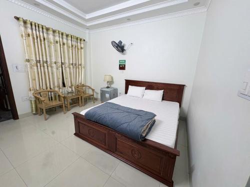a bedroom with a bed and a chair at Ninh Binh Friendly Hotel in Ninh Binh