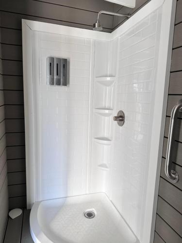 a white bathroom with a shower and a tub at Zaromelranch deck in Agua Dulce