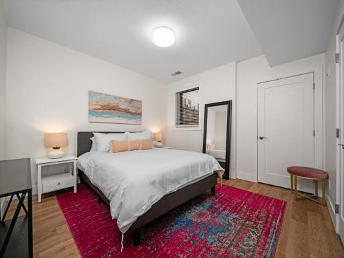 a bedroom with a large bed and a red rug at Cozy Capri Condo: Charming 1BR 1BA Downtown! in Traverse City