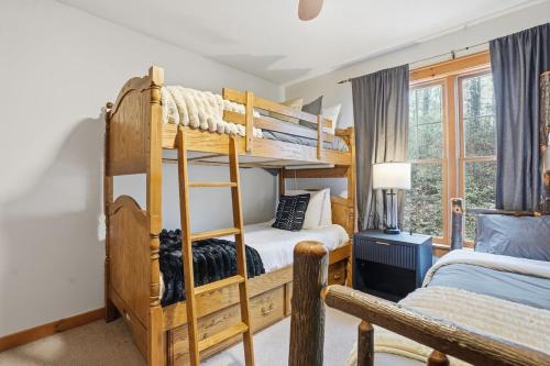 a bedroom with two bunk beds and a bed at Luxury Poconos Chalet - 3 Mins to Camelback in Tannersville