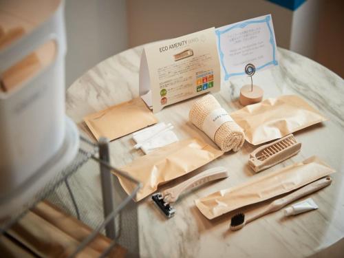 a glass table with a box and other items on it at Glory island okinawa SOBE in Naha