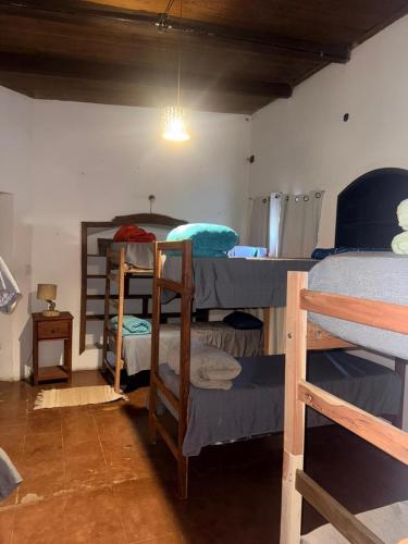 a room with three bunk beds in a room at Casona de los Molles in Tilcara