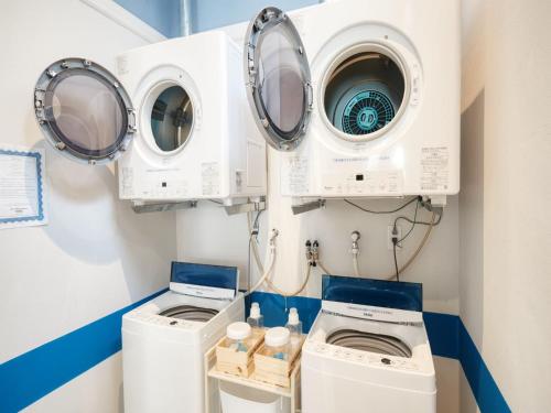 two washing machines and a washer and dryer in a room at Glory island okinawa SOBE in Naha