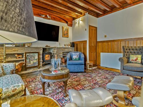 a living room filled with furniture and a fireplace at Steppe Haugh in Hawes