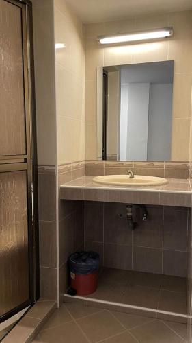 a bathroom with a sink and a mirror at Swing & Pillows - Bandar Kuantan in Kuantan