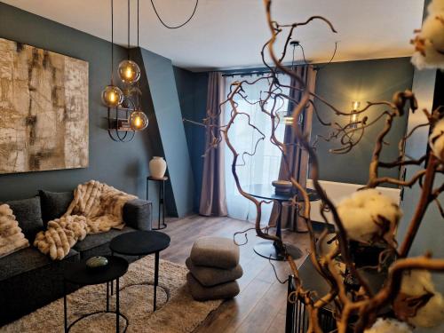 a living room with a couch and a tree at Maison Kolsaas in Vernon