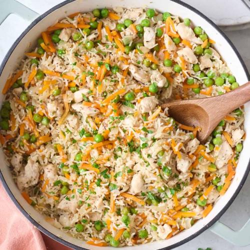 a pan filled with rice and vegetables with a wooden spoon at Peace and Quiet Dorm Rooms - Free Breakfast DIY Waffles - Free Dinner - Free Coffee - Longterm Ok! in Miami