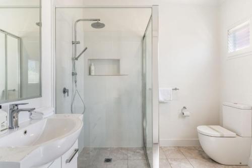 a bathroom with a shower and a sink and a toilet at Selah - 36 Woodburn Street in Evans Head