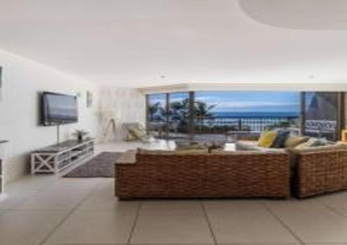 a living room with a couch and a view of the ocean at The Rocks Resort Unit 3C in Gold Coast