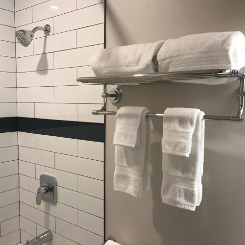 a bathroom with white towels on a towel rack at Kokanee Glacier Resort in Nelson