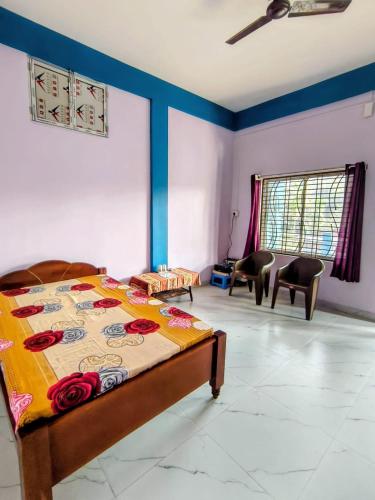 a bedroom with a bed and chairs in a room at Makum Homestay in Mākum